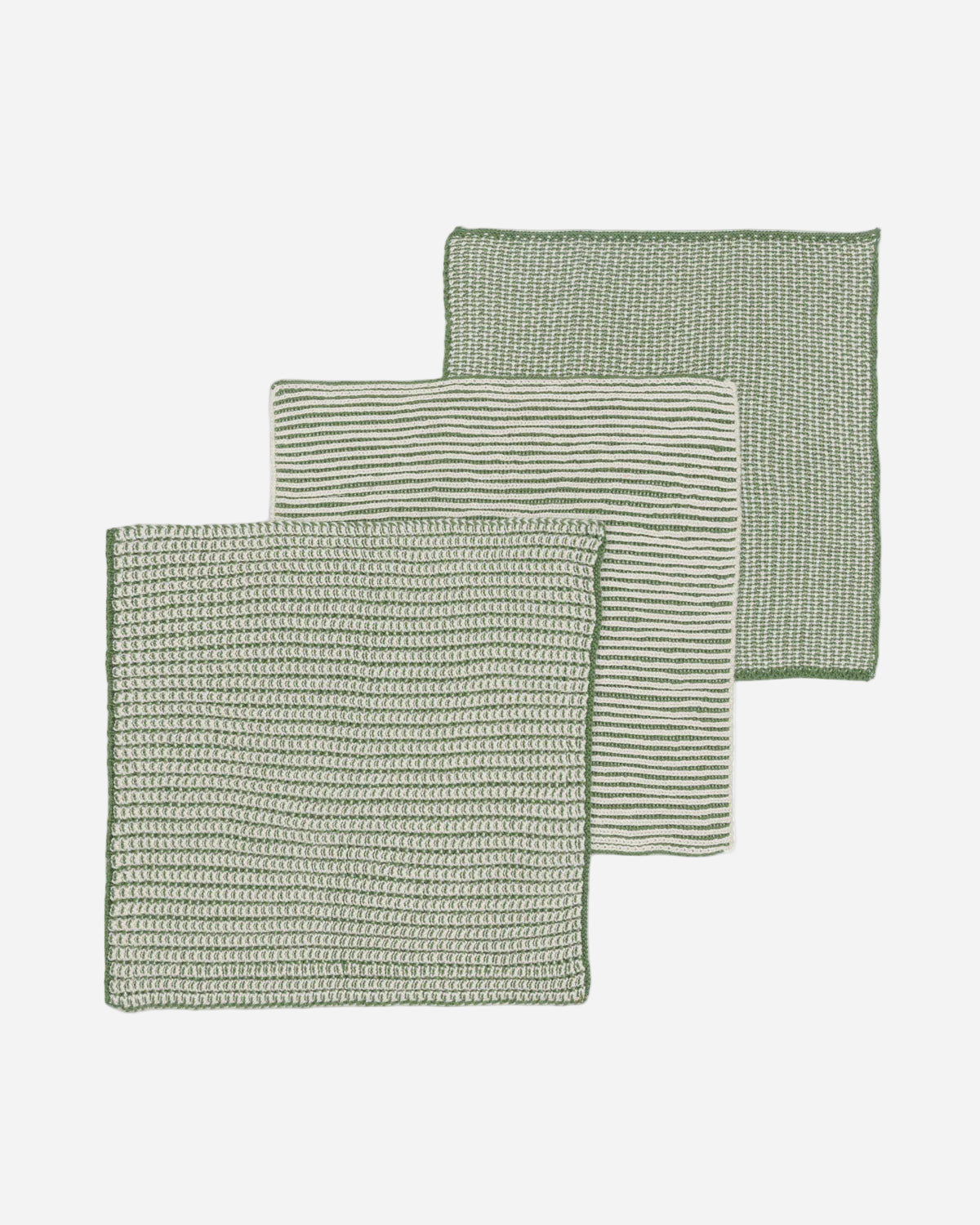 Three green textured cloths on a white background