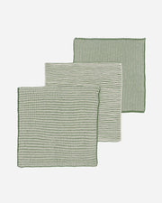 Three green textured cloths on a white background