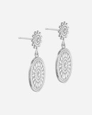Silver earrings with circular designs on a white background