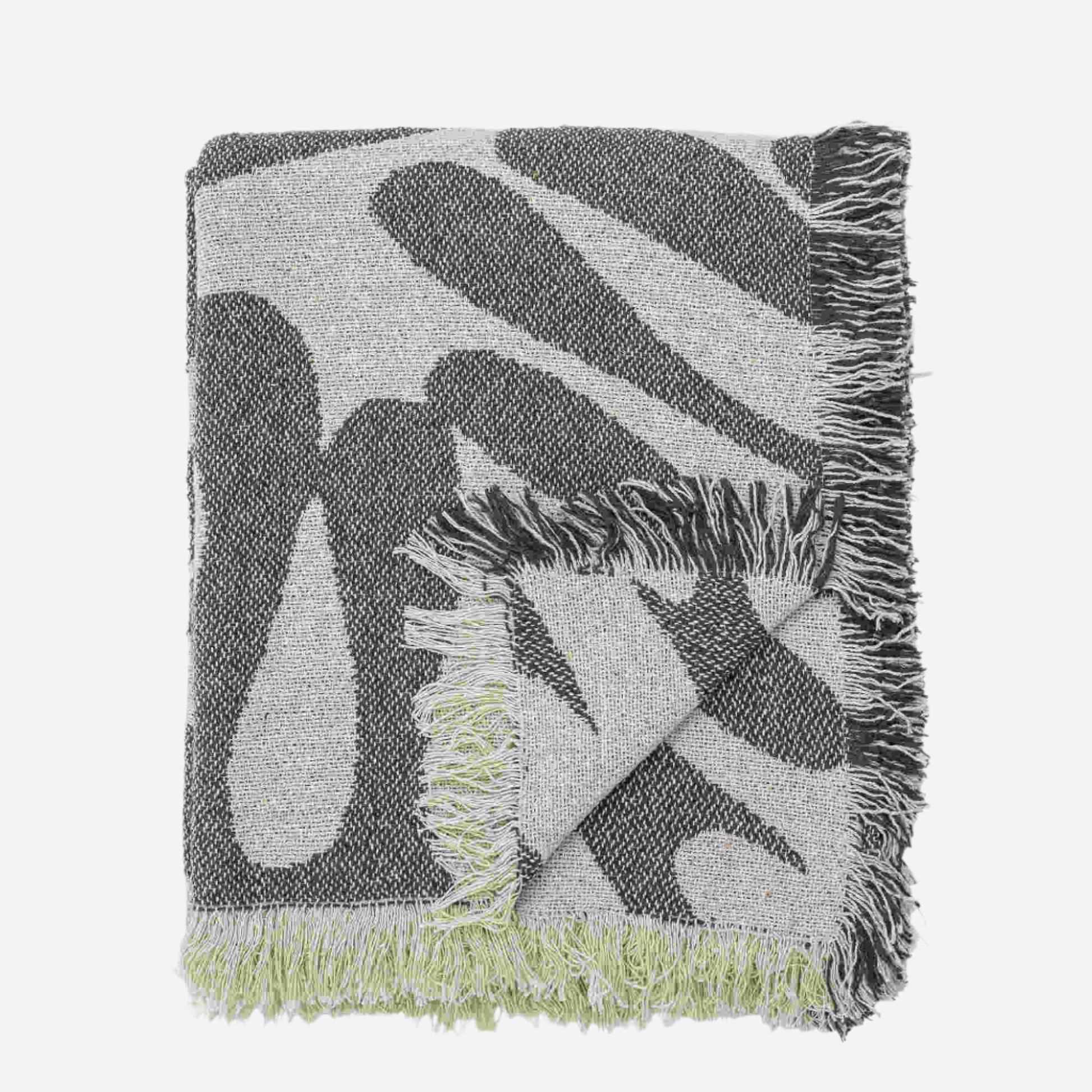 Green and white patterned throw
