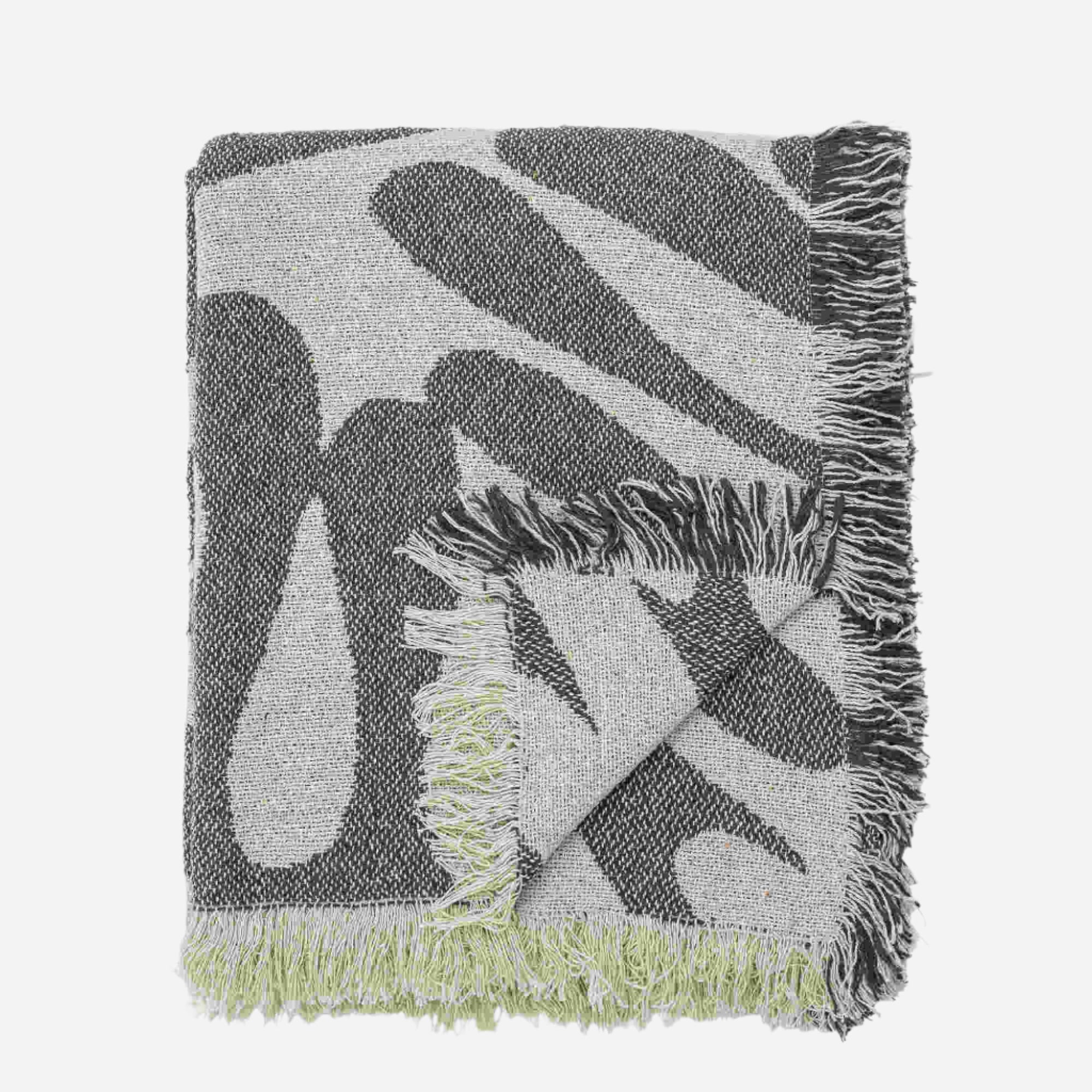 Green and white patterned throw