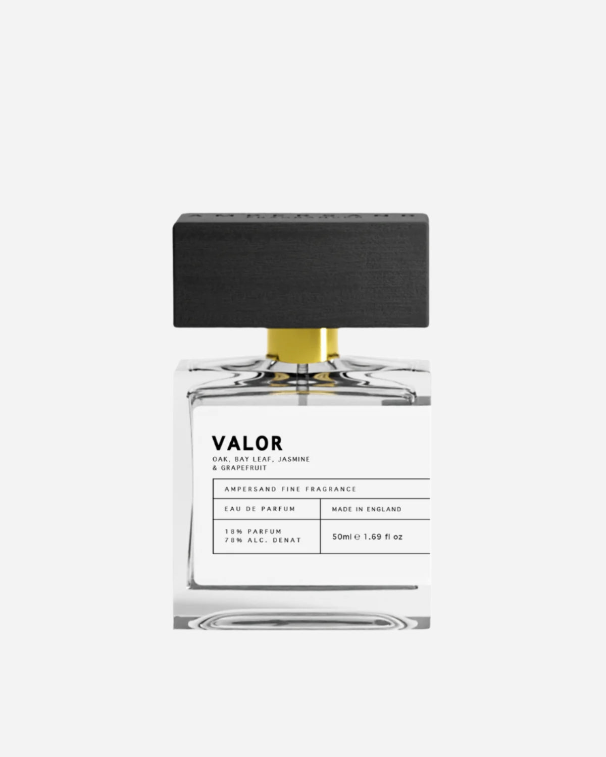 Clear perfume bottle with black and white printed label and black wooden cap with Ampersand engraving.