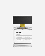 Clear perfume bottle with black and white printed label and black wooden cap with Ampersand engraving.