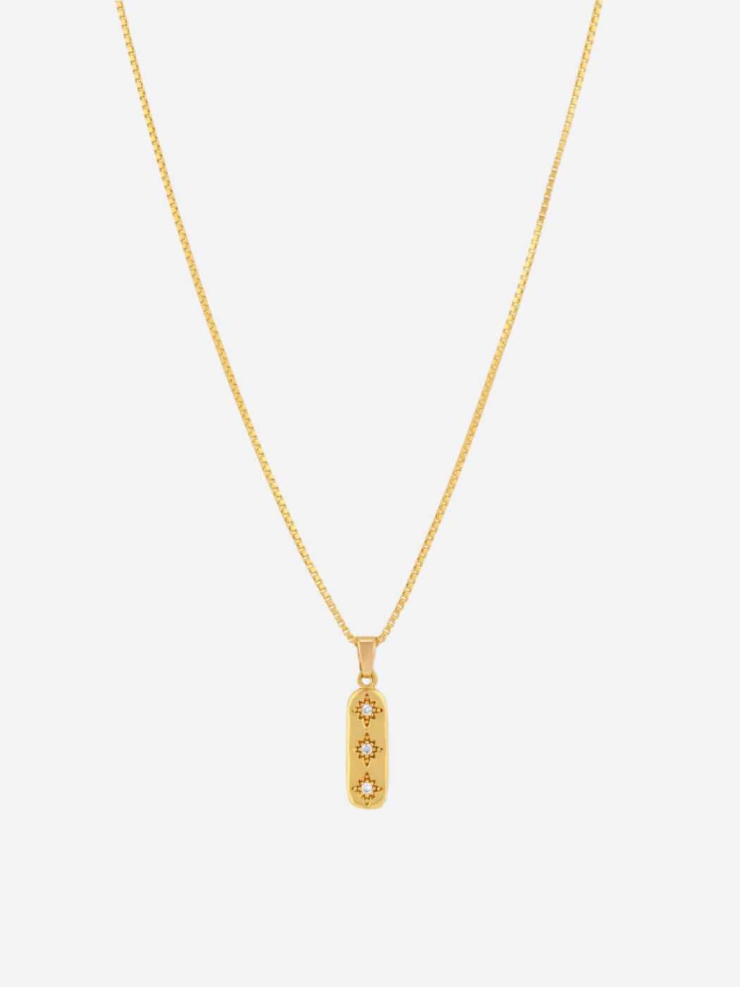A gold-colored necklace with a delicate chain and a linear charm featuring cubic zirconia, attached to a box clasp.