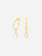 A pair of gold-colored hoop earrings with oval charms, displayed against a white background