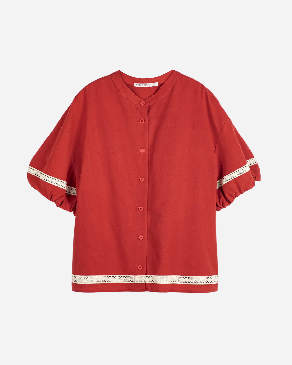 Red blouse with lace trim on a white background