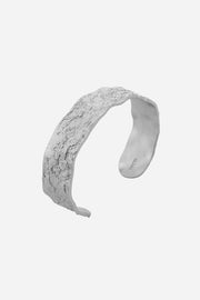 Silver headband on a light gray background