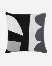 Decorative pillow with abstract black, gray, and white pattern on a white background