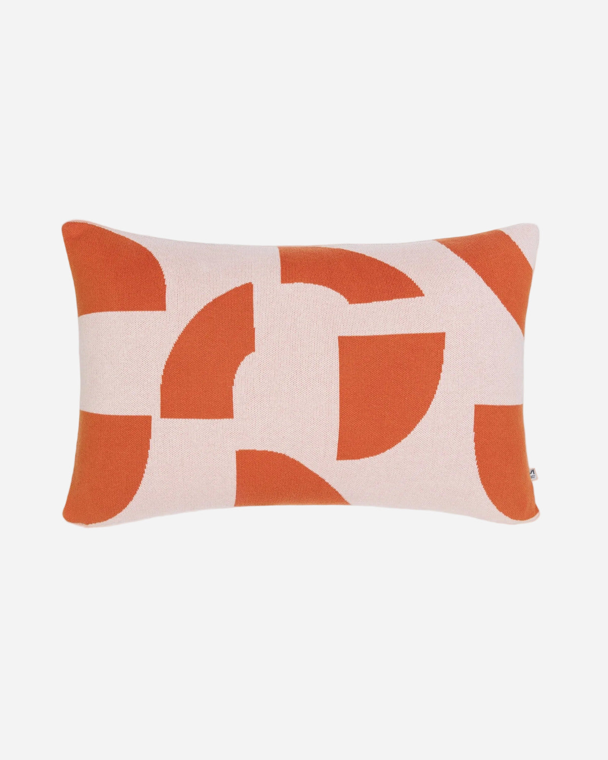 Decorative pillow with orange and beige abstract pattern on a white background