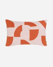 Decorative pillow with orange and beige abstract pattern on a white background