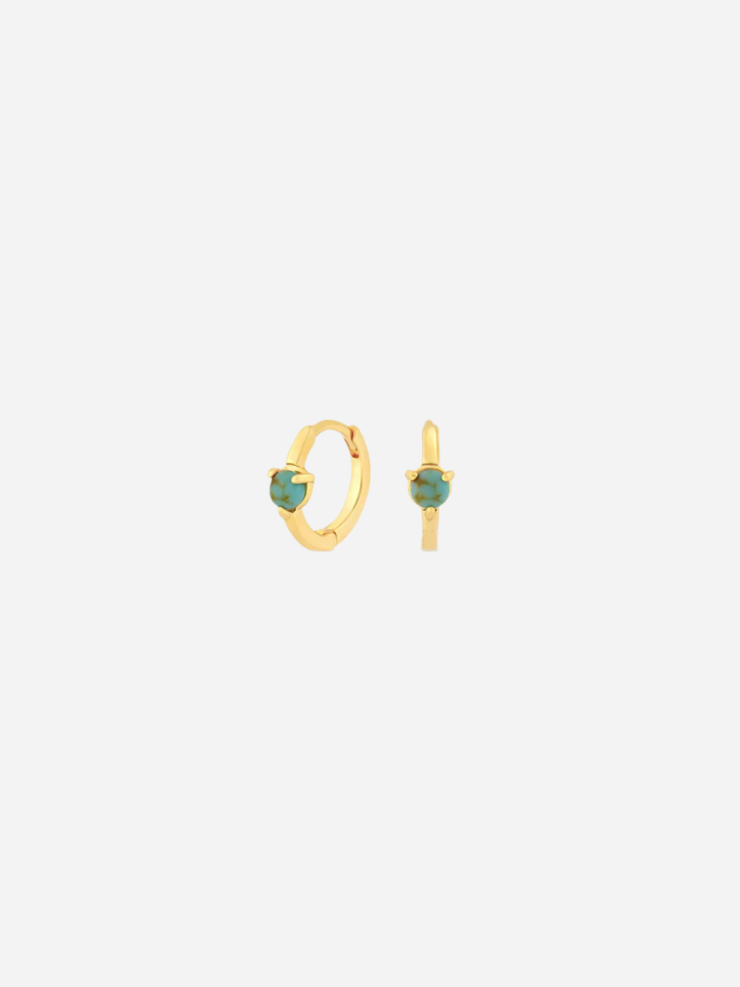 A pair of gold-colored huggie earrings with a single rounded turquoise stone on each