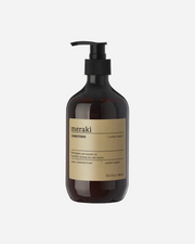 A pump bottle of Meraki Northern Dawn Conditioner with a brown label displaying the product name and organic certification.