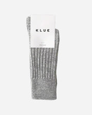 Gray socks with a KLUE label on a gray background