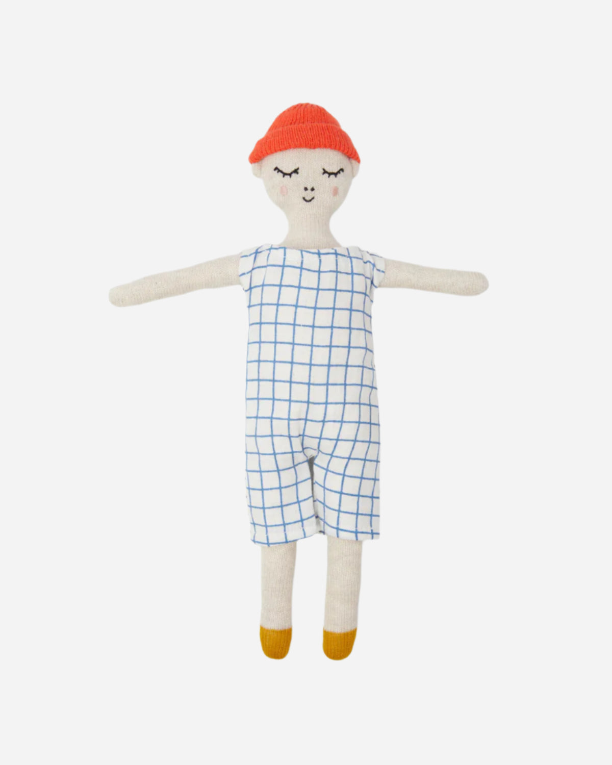 Textile doll with a red cap, blue checkered romper, and yellow shoes on a white background