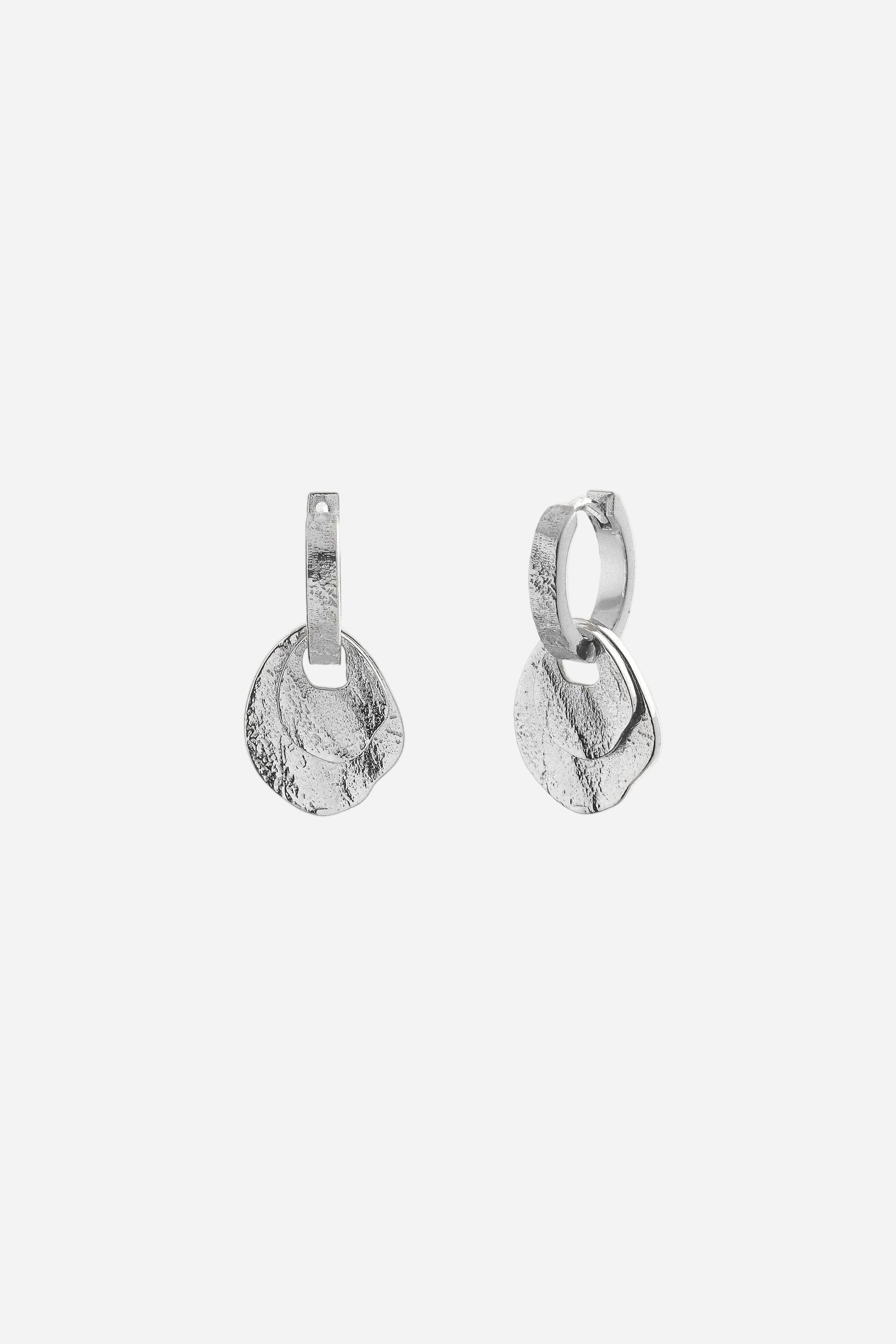 Pair of silver hoop earrings on a light gray background