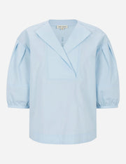 Light blue blouse with puff sleeves on a white background