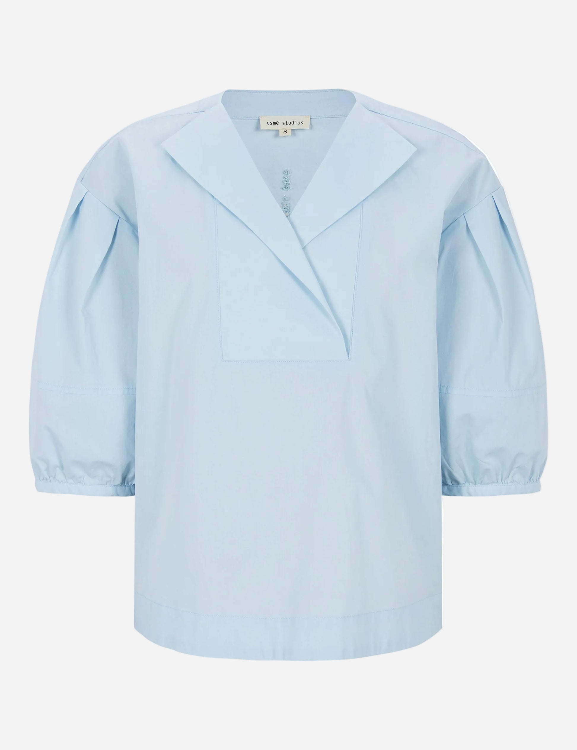 Light blue blouse with puff sleeves on a white background