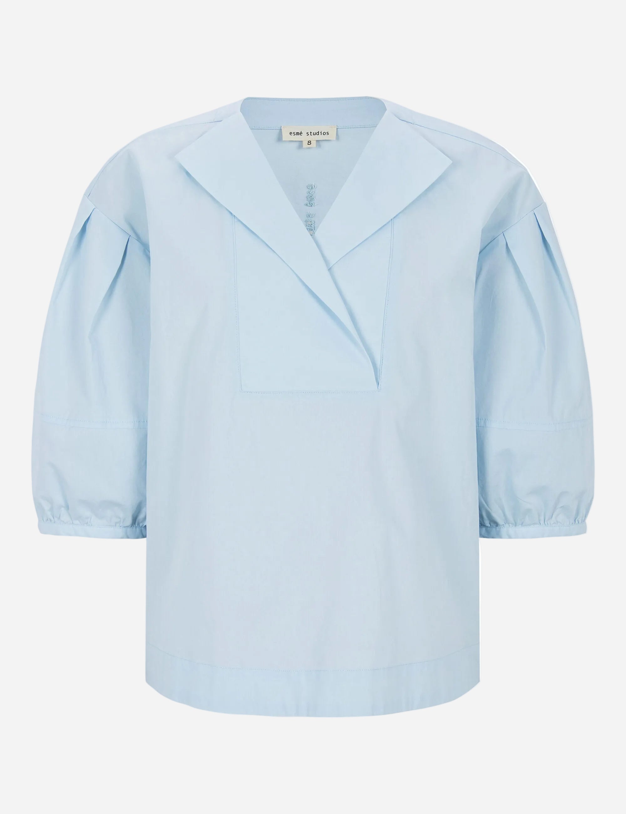 Light blue blouse with puff sleeves on a white background