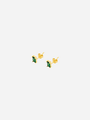 A pair of gold-colored stud earrings with baguette cut emerald stones.