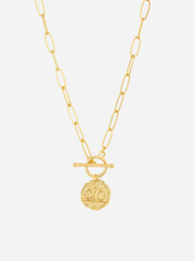 Gold necklace with a circular pendant on a white background
