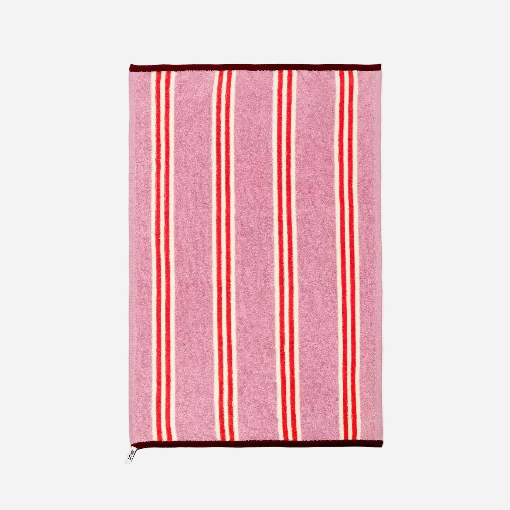 Pink towel with red stripes on a white background