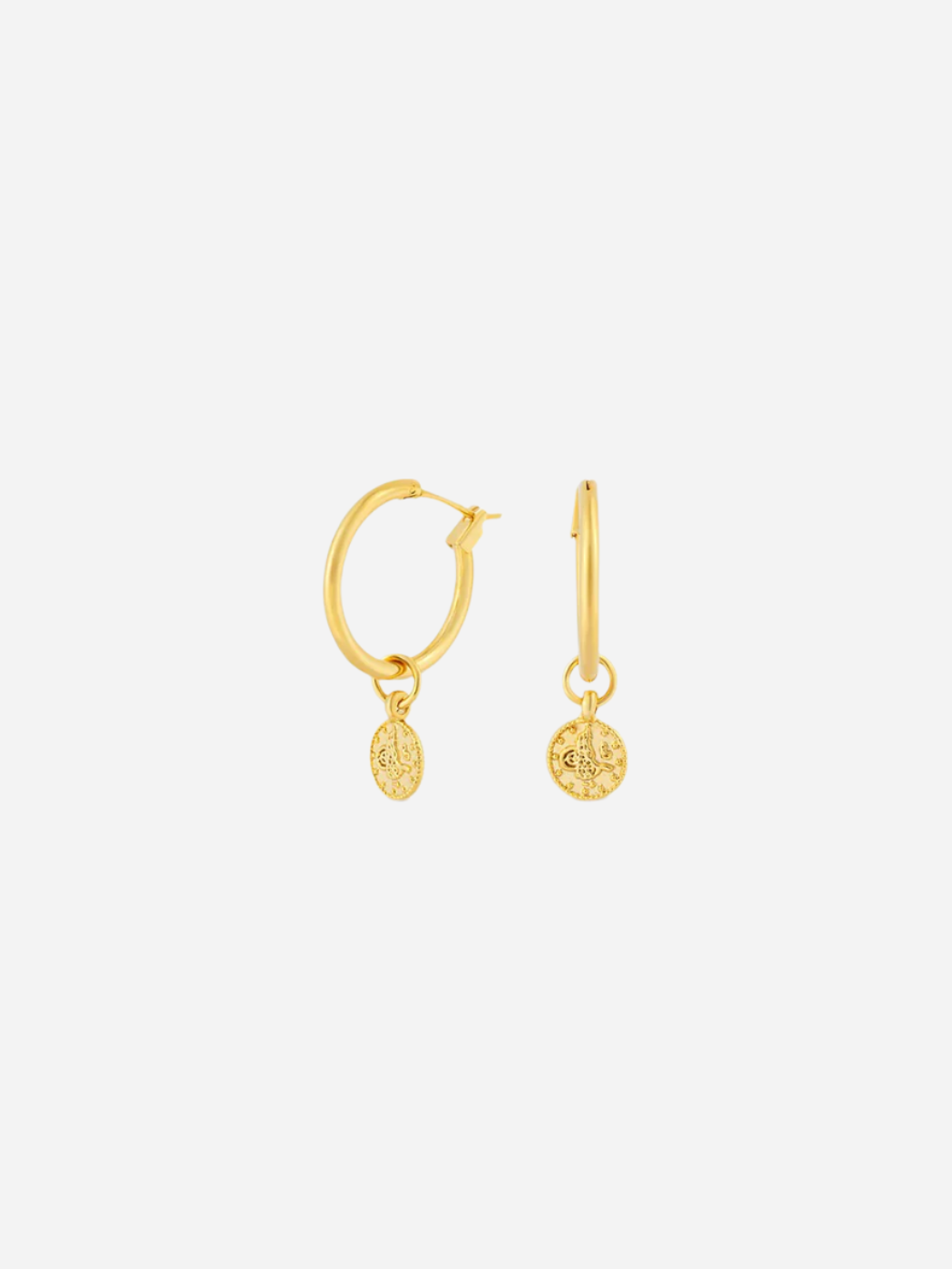 Gold hoop earrings with small round pendants on a white background
