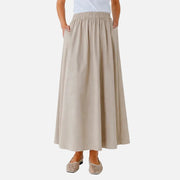 Beige skirt worn by a person on a white background