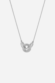 Silver necklace with a unique pendant on a light gray background