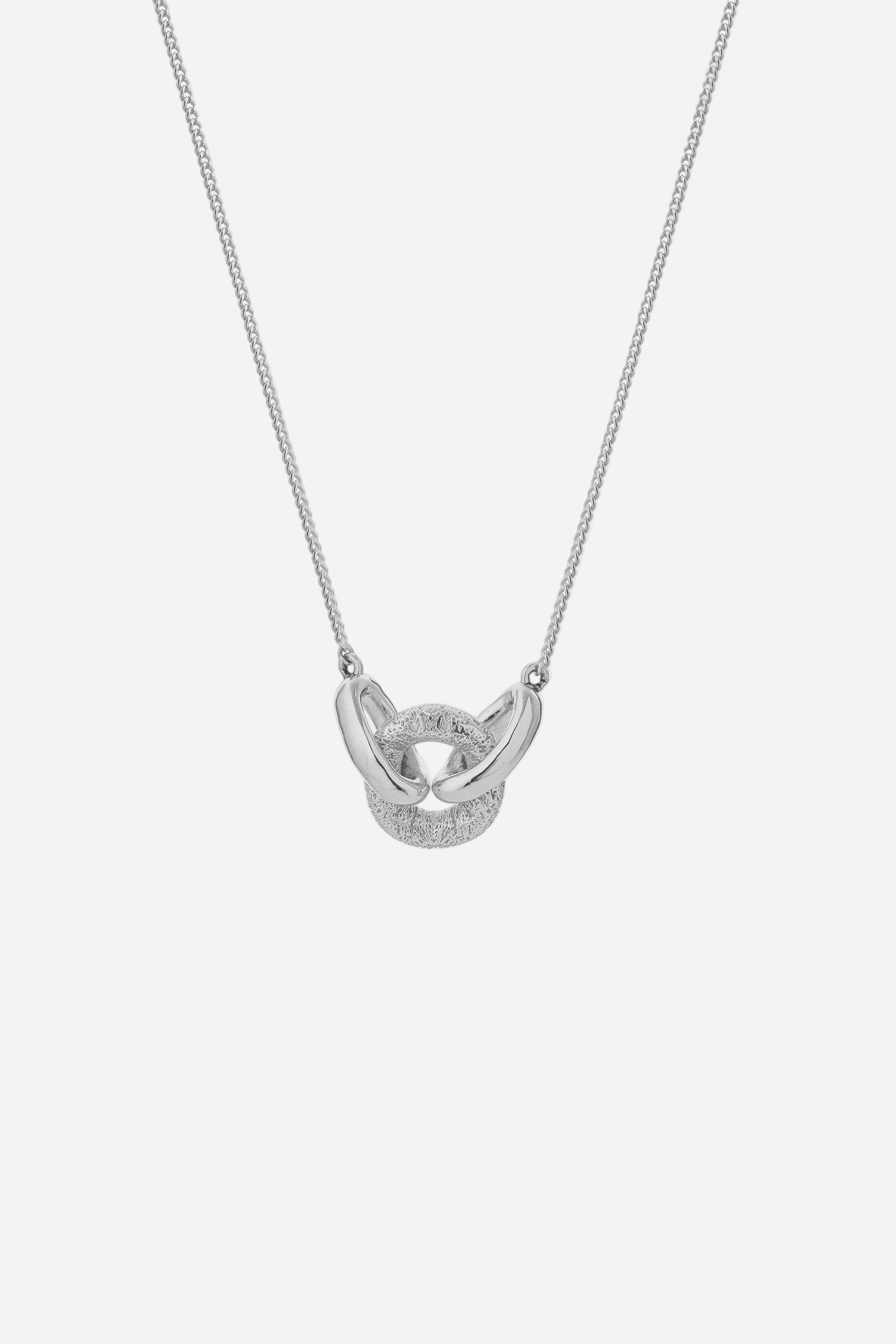 Silver necklace with a unique pendant on a light gray background