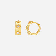 Gold hoop earrings with small diamonds on a white background