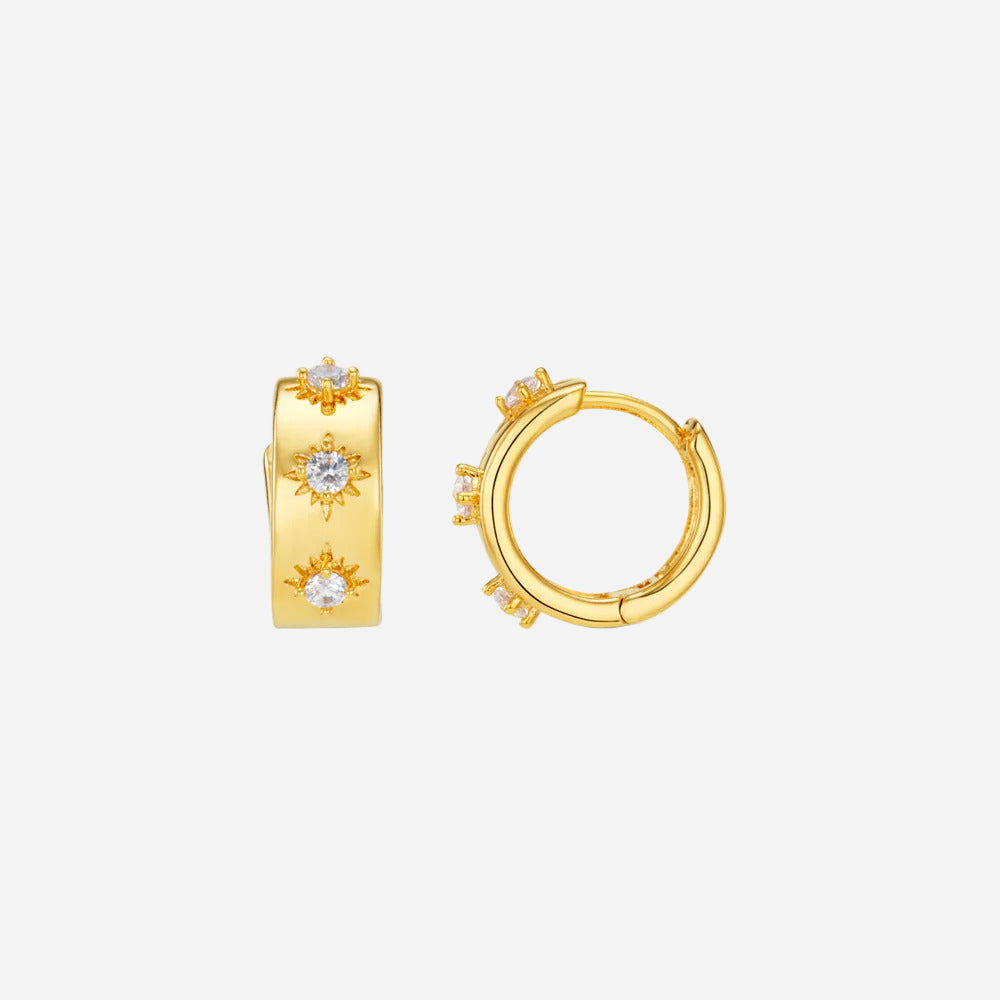 Gold hoop earrings with small diamonds on a white background
