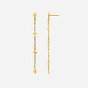 Gold earrings with diamond-like stones on a white background