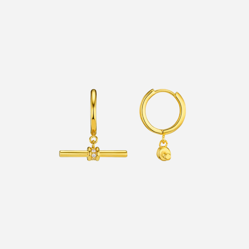 Gold hoop earrings with additional charms on a white background