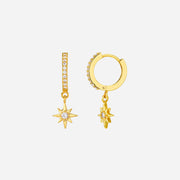 Gold hoop earrings with star-shaped charms on a white background