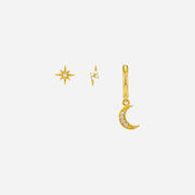 Gold jewelry set with star, moon, and diamond charm on a white background