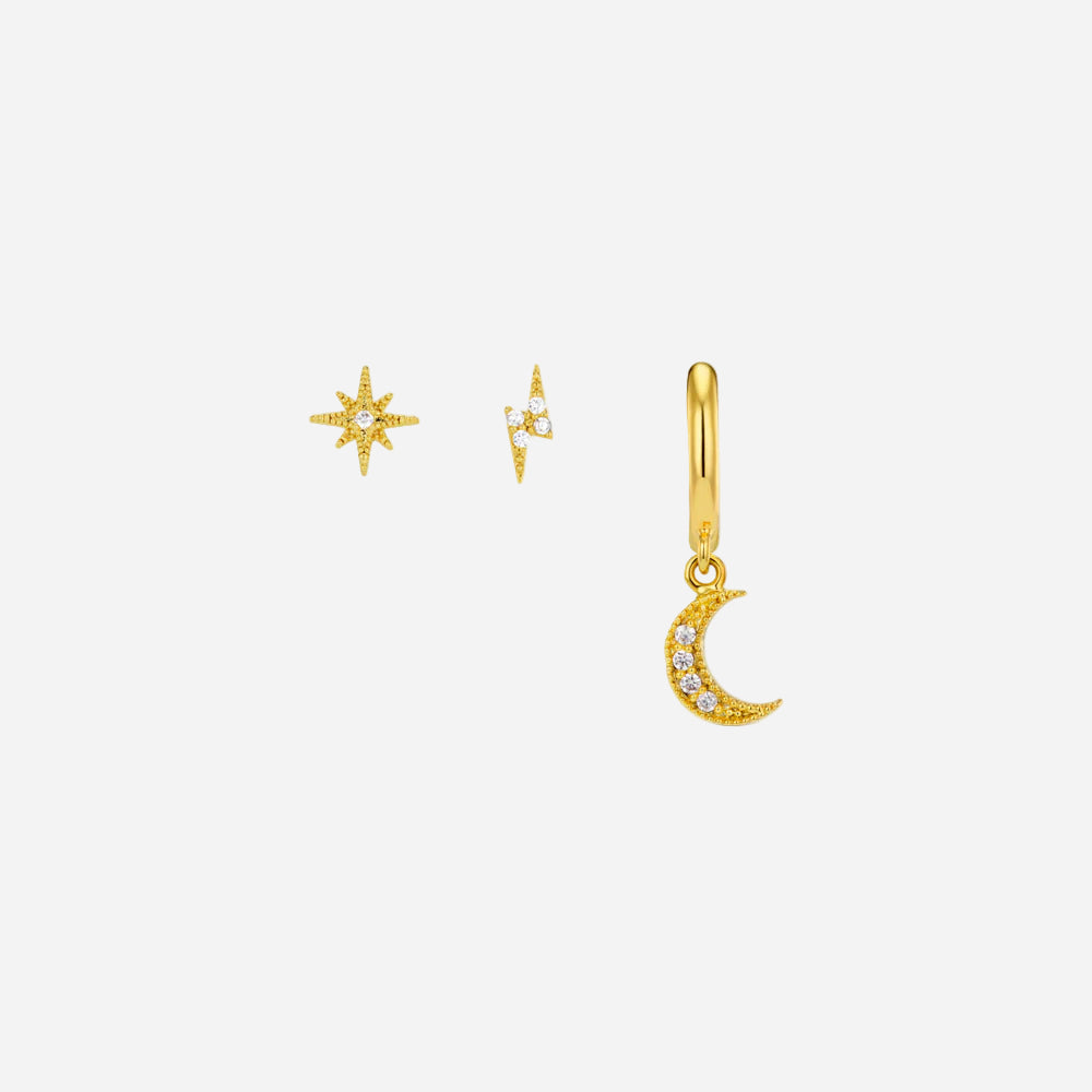 Gold jewelry set with star, moon, and diamond charm on a white background
