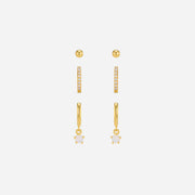 Set of gold earrings on a white background