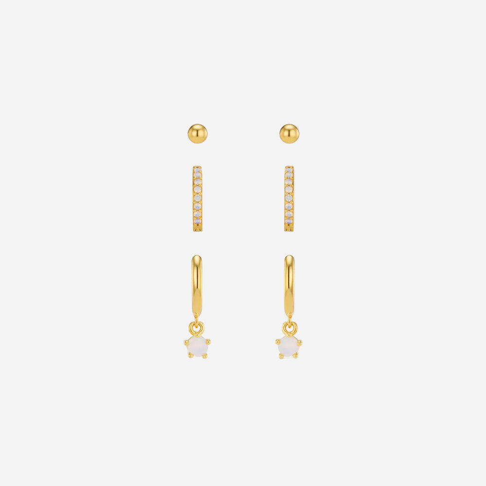 Set of gold earrings on a white background