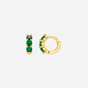 Gold hoop earrings with green gemstones on a white background