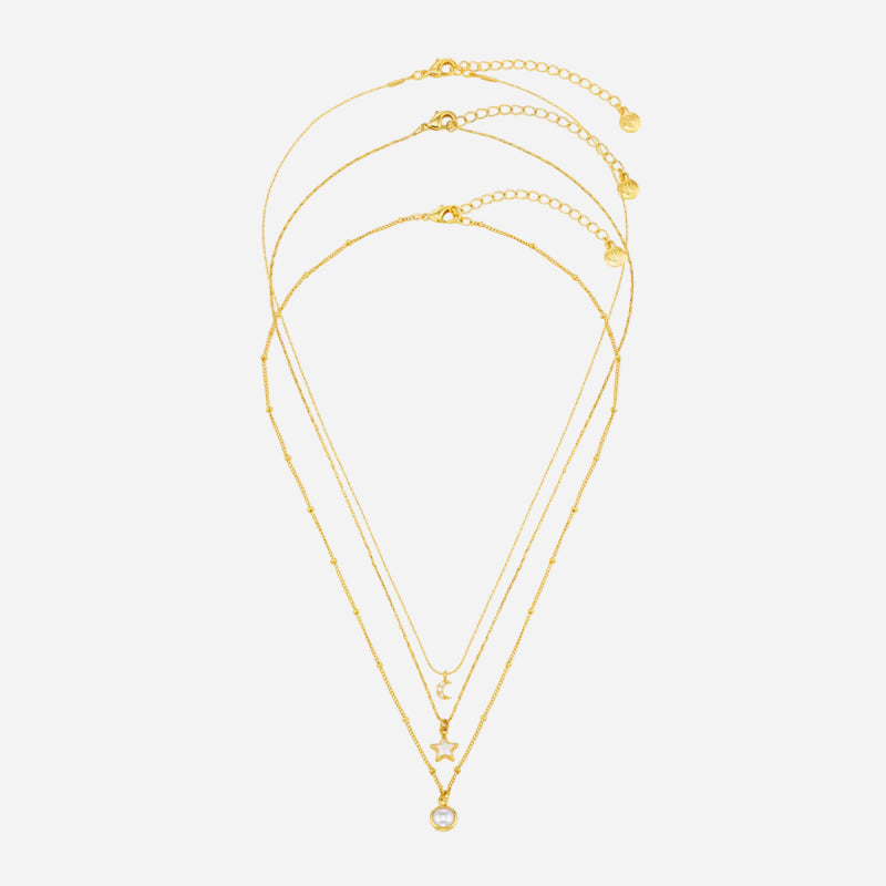 Set of three gold necklaces with star and heart pendants on a white background