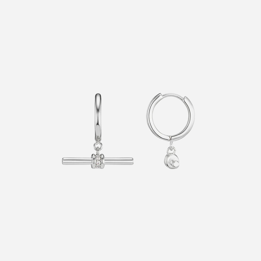 Two silver hoop earrings with small charms on a white background