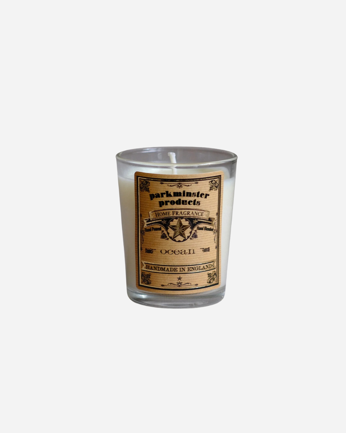 A clear glass mini votive candle with a label featuring the brand name Parkminster and product details.