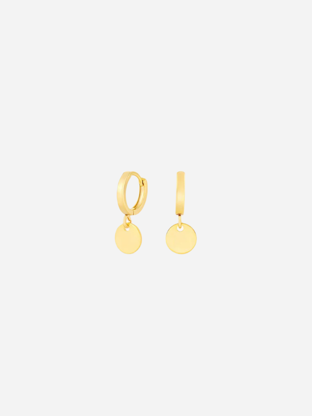 A pair of gold huggie earrings with two shiny circular disc charms attached to the hoop.