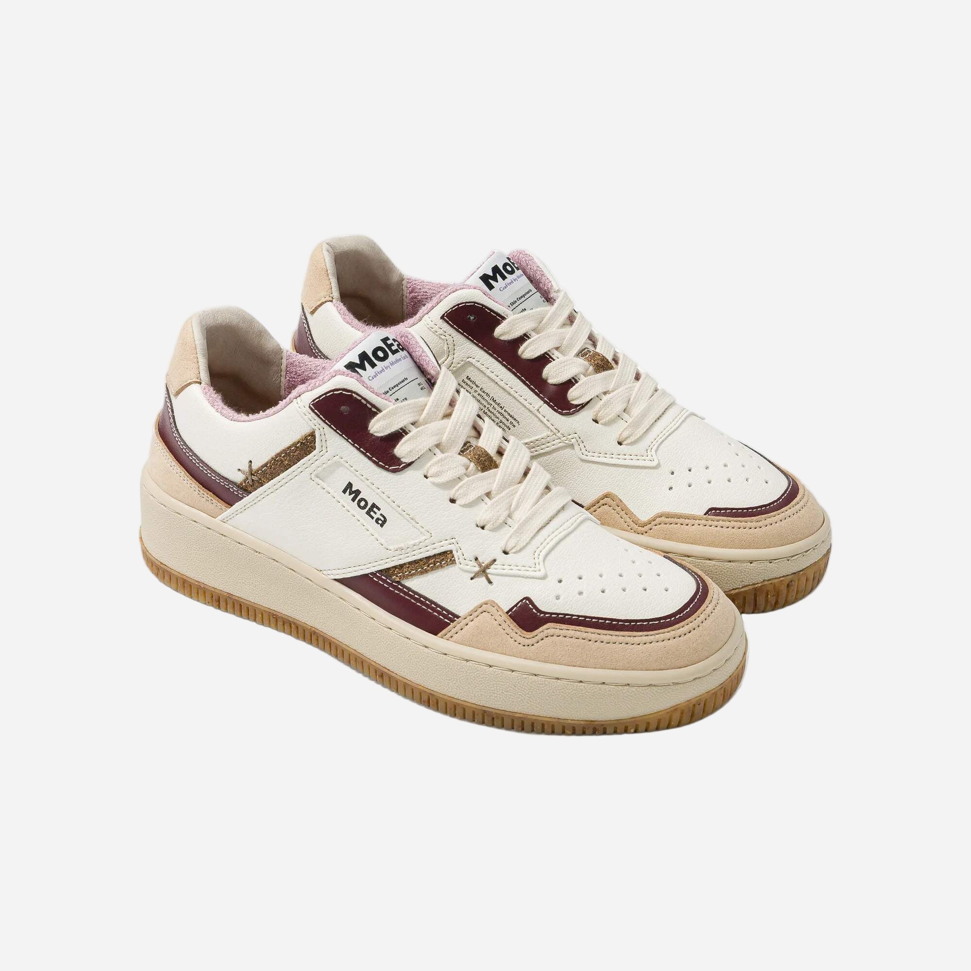 Pair of white and brown sneakers with 'Moe.' branding on a white background