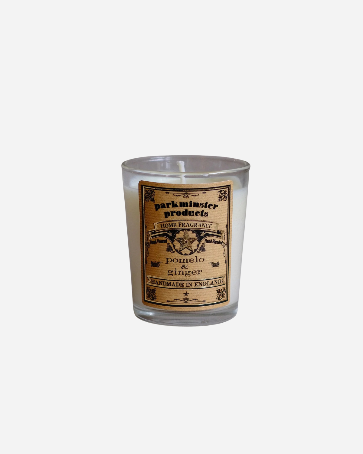 A mini votive candle with Pomelo & Ginger label, made by Parkminster, in a clear glass holder.