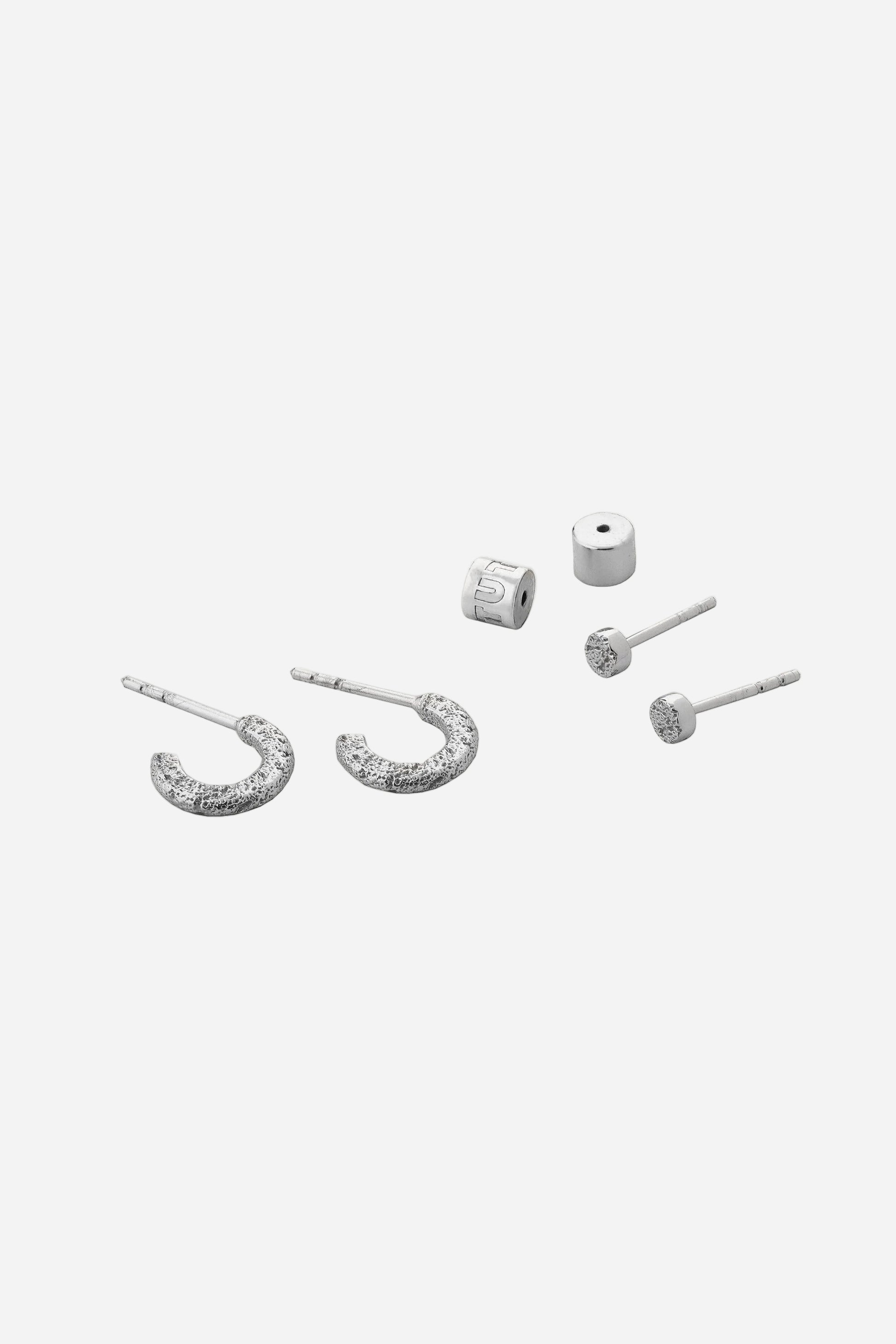 Set of silver earrings on a white background
