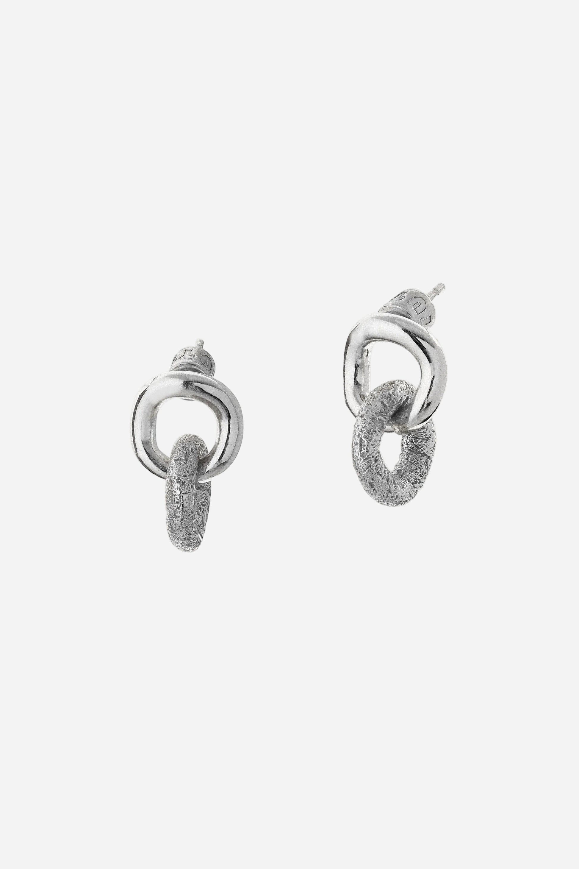 Pair of silver hoop earrings on a light gray background