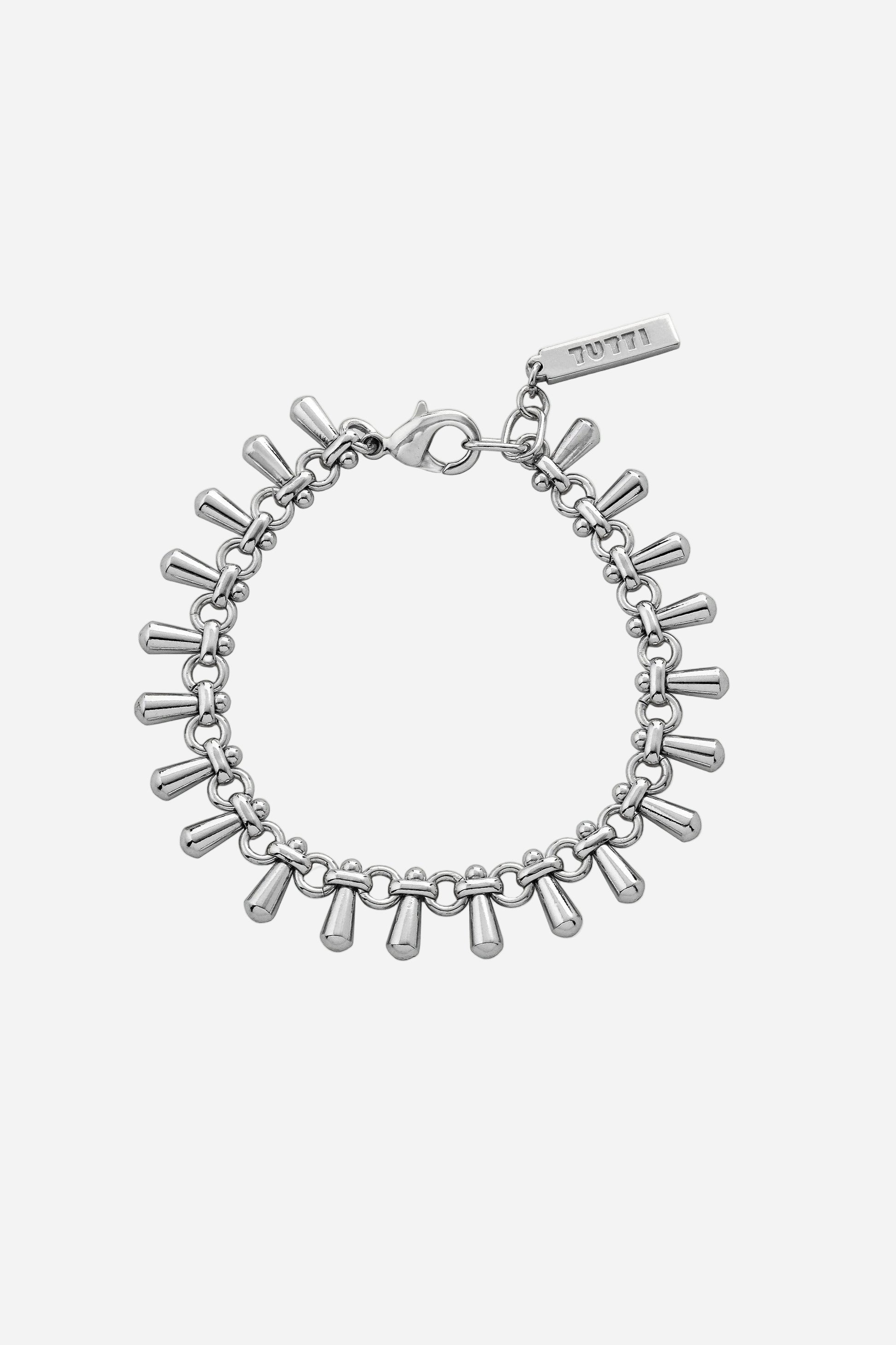 Silver bracelet with cylindrical charms on a light gray background