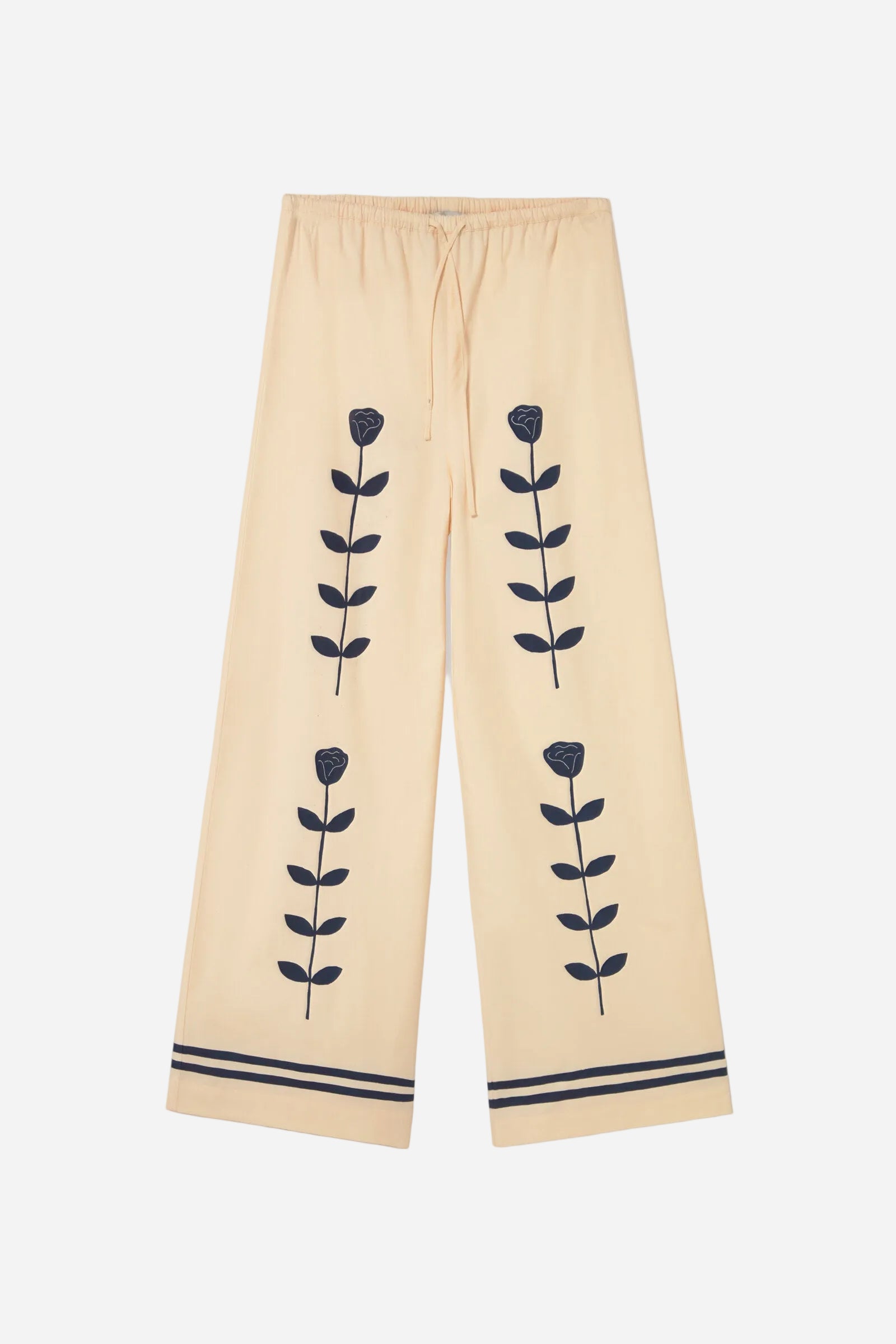 Beige pants with black floral patterns on a white background