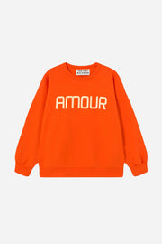 Red sweatshirt with 'AMOUR' text on a white background